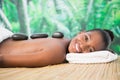 Pretty woman enjoying a hot stone massage Royalty Free Stock Photo