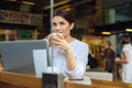 Pretty woman enjoying latte at cafe counter Royalty Free Stock Photo