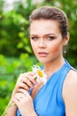 Pretty woman with flower in garden Royalty Free Stock Photo