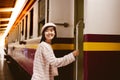 Pretty woman is getting in the train at train station for going back home by using public train. Attractive beautiful woman gets Royalty Free Stock Photo
