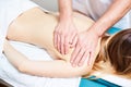 Pretty woman or girl with body and male hands of masseur therapist makes massage in beauty spa salon Royalty Free Stock Photo