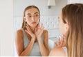 Pretty woman,girl touching her neck while looking in the mirror, beauty and fashion concept,wrinkles Royalty Free Stock Photo