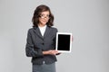 Pretty woman in glasses showing blank tablet computer screen Royalty Free Stock Photo