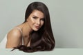 Pretty woman hair model with long healthy hairstyle on white background. Haircare and facial treatment concept Royalty Free Stock Photo