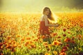 Pretty woman or happy girl in field of poppy seed Royalty Free Stock Photo