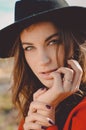 Pretty woman in hat looking at camera on autumn Royalty Free Stock Photo