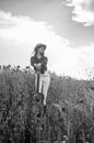 pretty woman in hat walking in poppy field. girl in meadow. romantic mood. beauty of spring nature. happy girl with