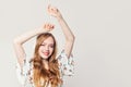 Pretty woman having fun with headphones. Redhead model girl listening music on white Royalty Free Stock Photo