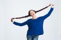 Pretty woman holding her two long braids and sending kiss Royalty Free Stock Photo