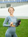 Pretty woman holding jump rope and bottle of water ready for her training exercises Royalty Free Stock Photo