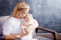 Pretty woman holding a newborn baby girl in her arms. Happy moth Royalty Free Stock Photo