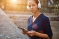 Pretty woman holding tablet and wearing headset. Study while travel idea. Studentship and distance learning concept Royalty Free Stock Photo