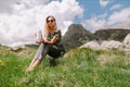 Pretty woman holding tea mug and travel in mountains on vacations Royalty Free Stock Photo