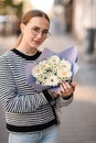 pretty woman holds bouquet of white flowers gerbera chrysanthemum and chamomile Royalty Free Stock Photo