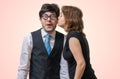 Pretty woman is kissing surprised nerd