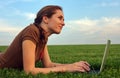 Pretty woman with laptop on the green grass Royalty Free Stock Photo