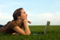 Pretty woman with laptop on the green grass Royalty Free Stock Photo