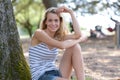 Pretty woman leaning against on tree and relaxing Royalty Free Stock Photo