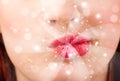 Pretty woman lips blowing abstract white lights Royalty Free Stock Photo