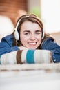 Pretty woman listening music lying on the floor Royalty Free Stock Photo