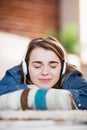 Pretty woman listening music lying on the floor Royalty Free Stock Photo