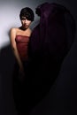 Pretty woman with long dark purple skirt Royalty Free Stock Photo