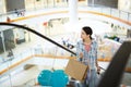 Pretty woman looking around while moving up escalator Royalty Free Stock Photo