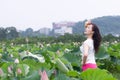 A pretty woman in lotu fields