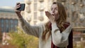 Pretty woman making selfie photo by phone. Cute girl doing pics by camera. Royalty Free Stock Photo