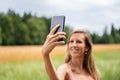 Pretty woman making selfies outside Royalty Free Stock Photo