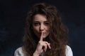 Pretty woman making silence sign with copy space on black background Royalty Free Stock Photo