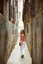 Pretty woman in narrow Venice street Royalty Free Stock Photo