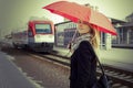 Pretty woman near the train travelling in station Royalty Free Stock Photo