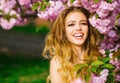 Pretty woman in pink blossom park. Happy young girl with smiling face enjoy spring. Royalty Free Stock Photo