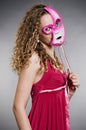 Pretty woman in pink mask