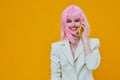 pretty woman pink wig white jacket phone technology Royalty Free Stock Photo