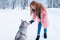 Pretty woman with playful husky dog