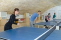 Pretty woman playing ping-pong with friends Royalty Free Stock Photo