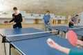 Pretty woman playing ping-pong with friends Royalty Free Stock Photo