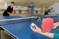 Pretty woman playing ping-pong with friends Royalty Free Stock Photo