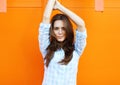 Pretty woman posing against bright colorful wall Royalty Free Stock Photo