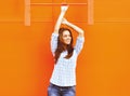 Pretty woman posing near bright colorful wall in the urban style Royalty Free Stock Photo