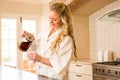 Pretty woman pouring coffee in a mug Royalty Free Stock Photo