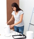 Pretty woman preparing white paint to renovate Royalty Free Stock Photo