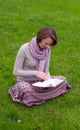 Pretty woman reading a book on a grass Royalty Free Stock Photo