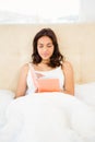 Pretty woman reading book in her bed Royalty Free Stock Photo