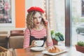 Pretty woman in red beret with smartphone Royalty Free Stock Photo