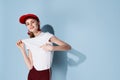 pretty woman in red cap posing fashion summer blue background Royalty Free Stock Photo