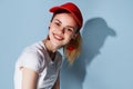 pretty woman in red cap posing fashion summer blue background Royalty Free Stock Photo