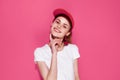 pretty woman in red cap posing fashion summer style pink background Royalty Free Stock Photo